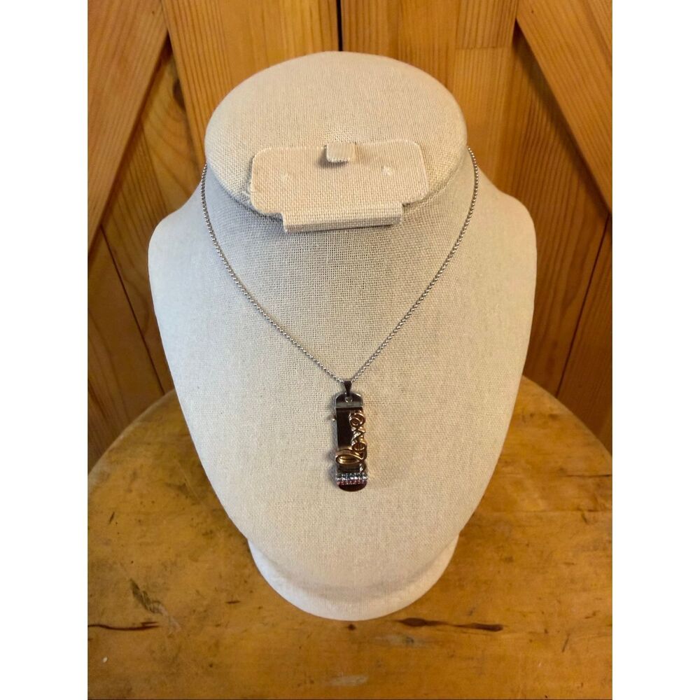 Keep Collective pendant necklace features a customizable charm that spells "Love